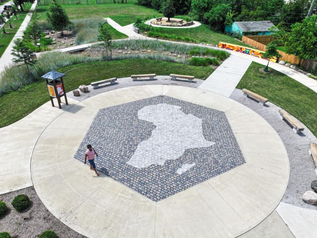 Concrete pad with pavers in the middle and the shape of Africa in the middle