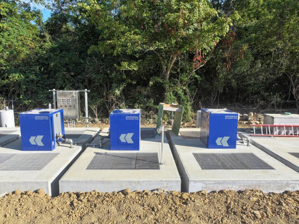Three machines labeled "Universal Blower Pac" sitting on concrete pads.