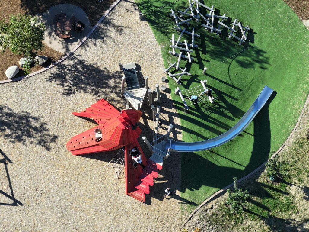 Playground with a metal slide and organic-shaped