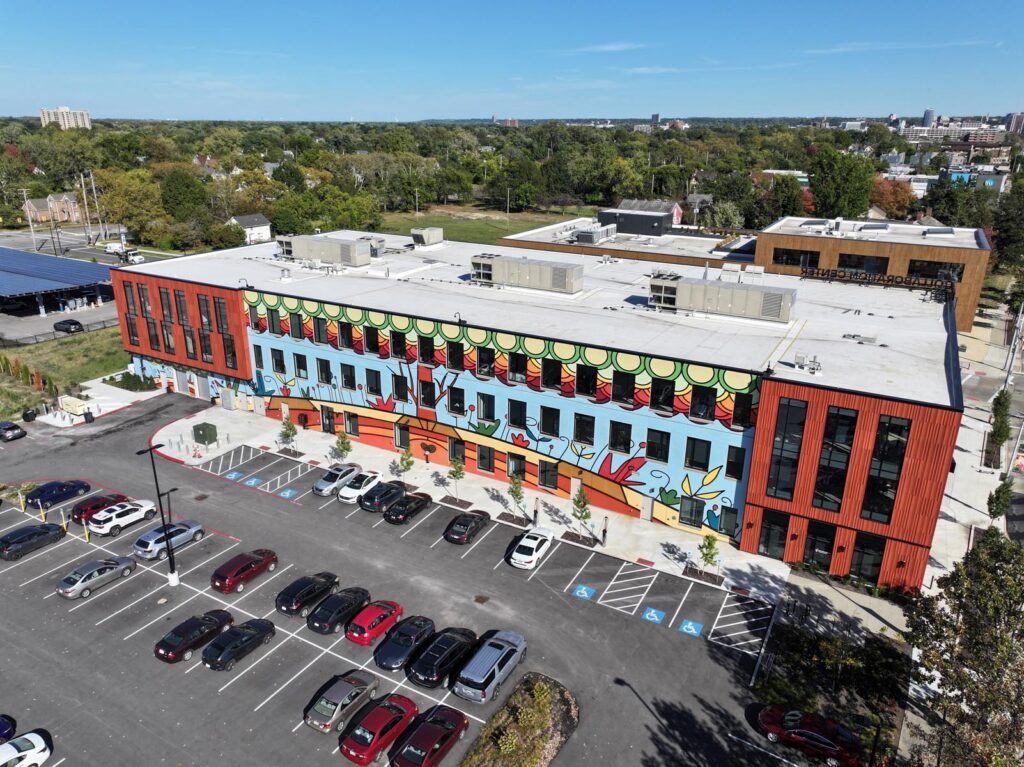 Large warehouse building with a mural across the front