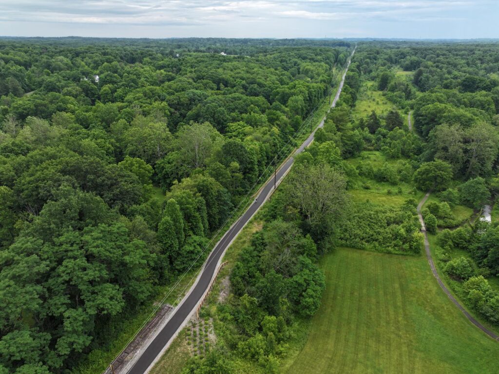 Lush green landscape with a trail cutting through the center