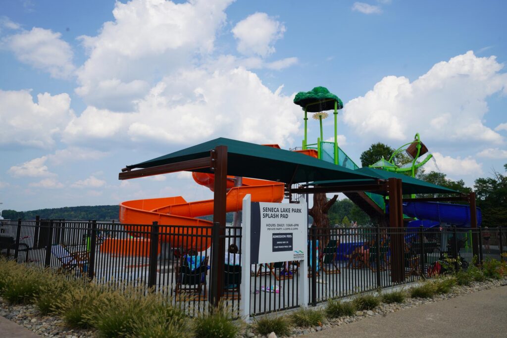 Splash pad with slide and clouds above