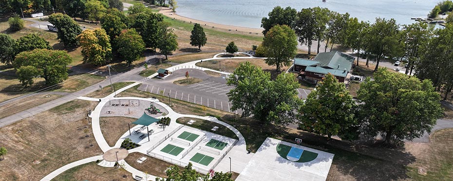 Aerial view of a campground with tennis courts and a basketball court