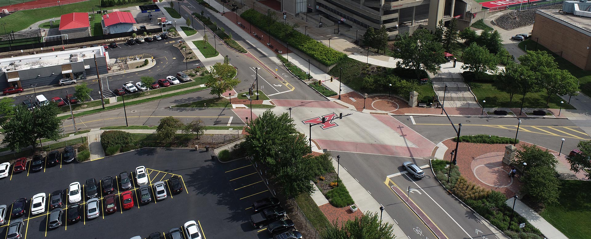 Aerial view of a four way intersection with crosswalks on every side and the Youngstown State logo in the middle