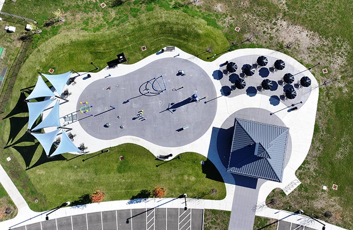 Aerial view of a modern playground with shade on both sides
