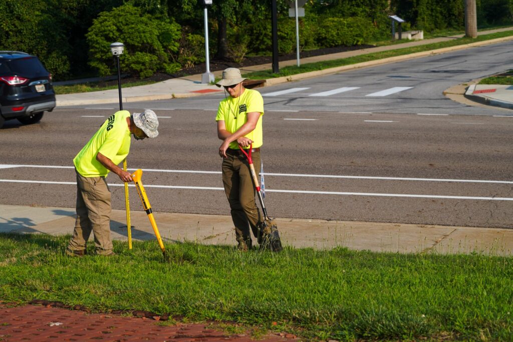 Two men in neon EDG shirts surveying